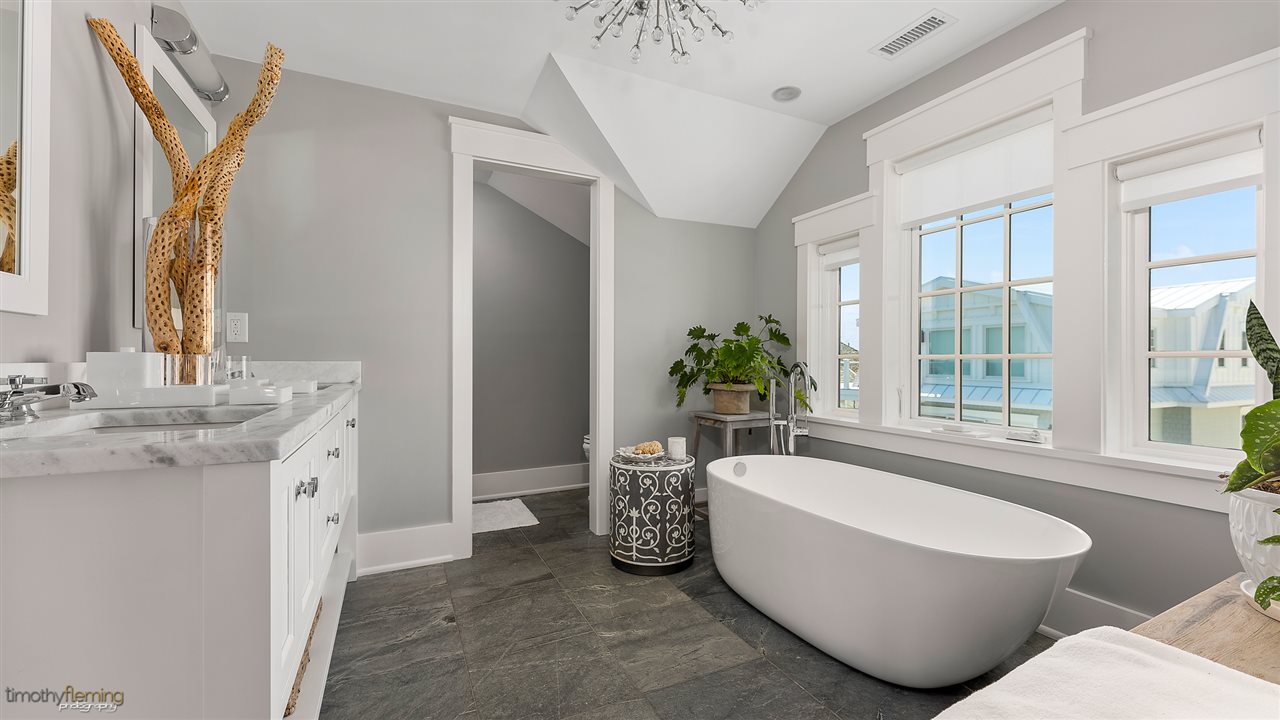 74 38th Street Avalon, NJ 08202 - Photo 31 of 39 a spacious bathroom with a granite countertop tub a sink and a large window