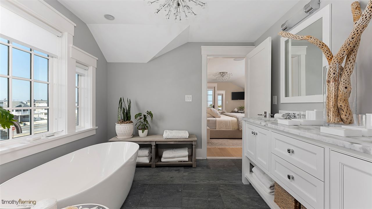 74 38th Street Avalon, NJ 08202 - Photo 32 of 39 a bathroom with a tub a sink and a window