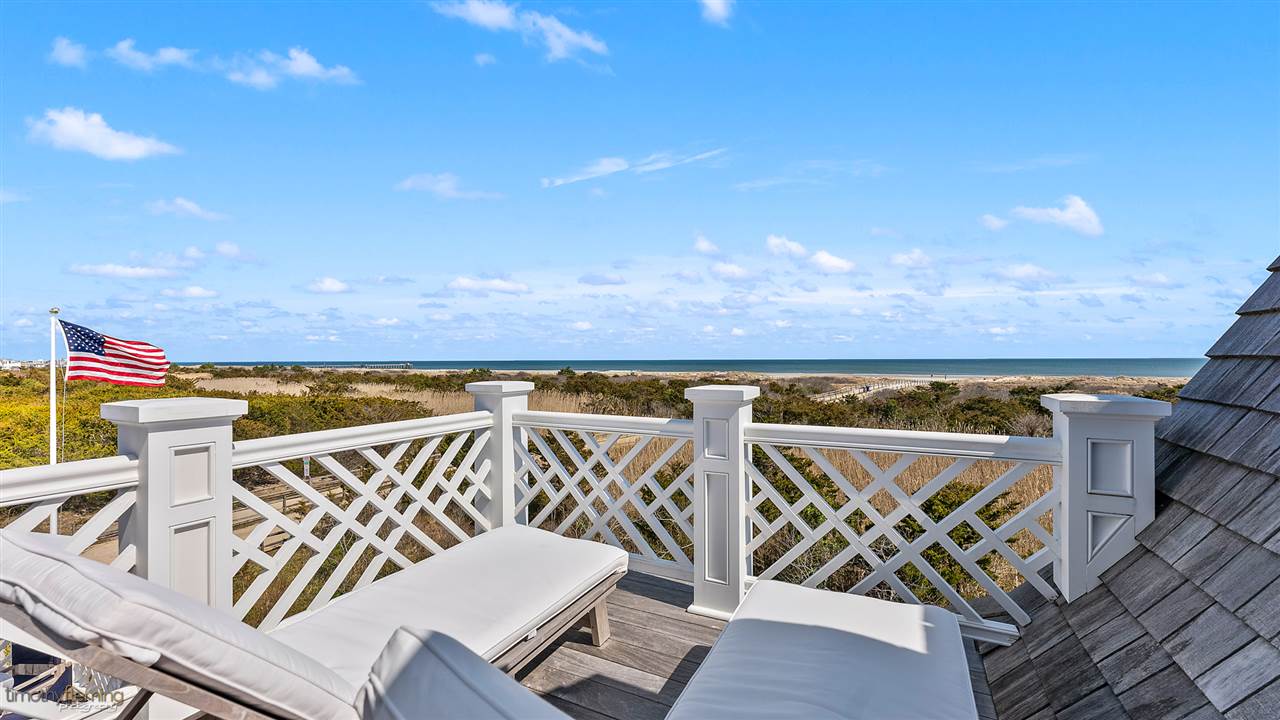 74 38th Street Avalon, NJ 08202 - Photo 34 of 39 a view of a patio with table and chairs with wooden floor and fence