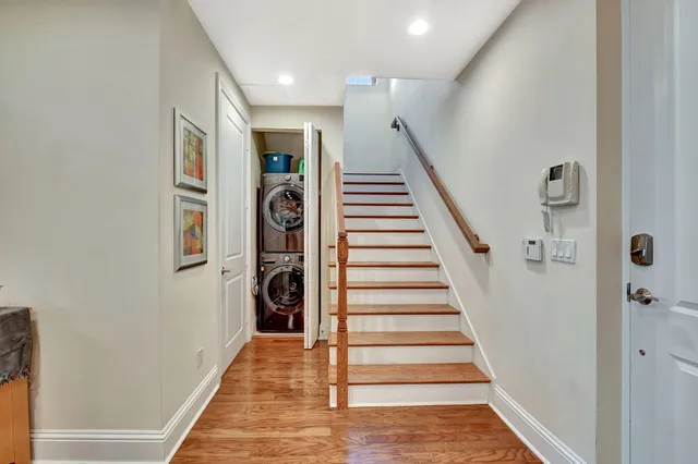 a kitchen with stainless steel appliances granite countertop a table chairs refrigerator and a stove top oven