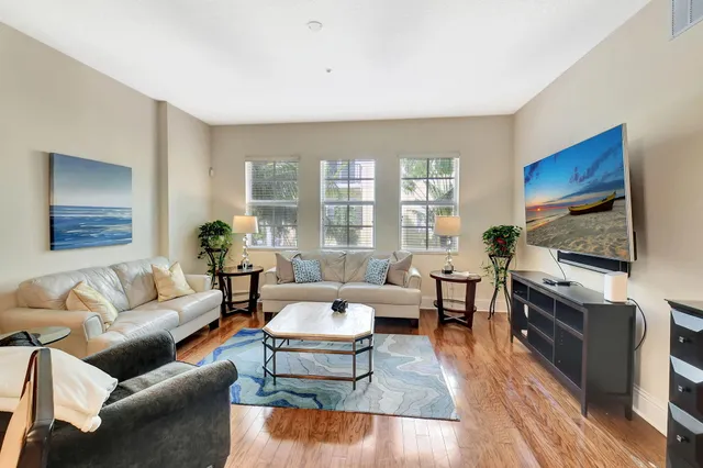 a living room with furniture and a large mirror