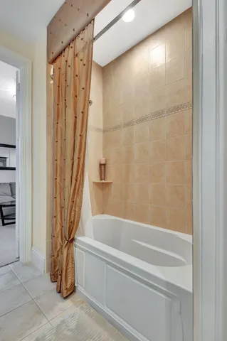 a living room with furniture a flat screen tv and a floor to ceiling window