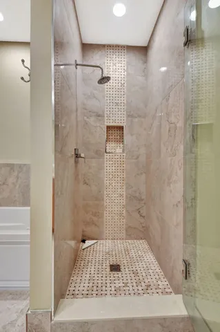 a view of a patio with couches table and chairs under an umbrella