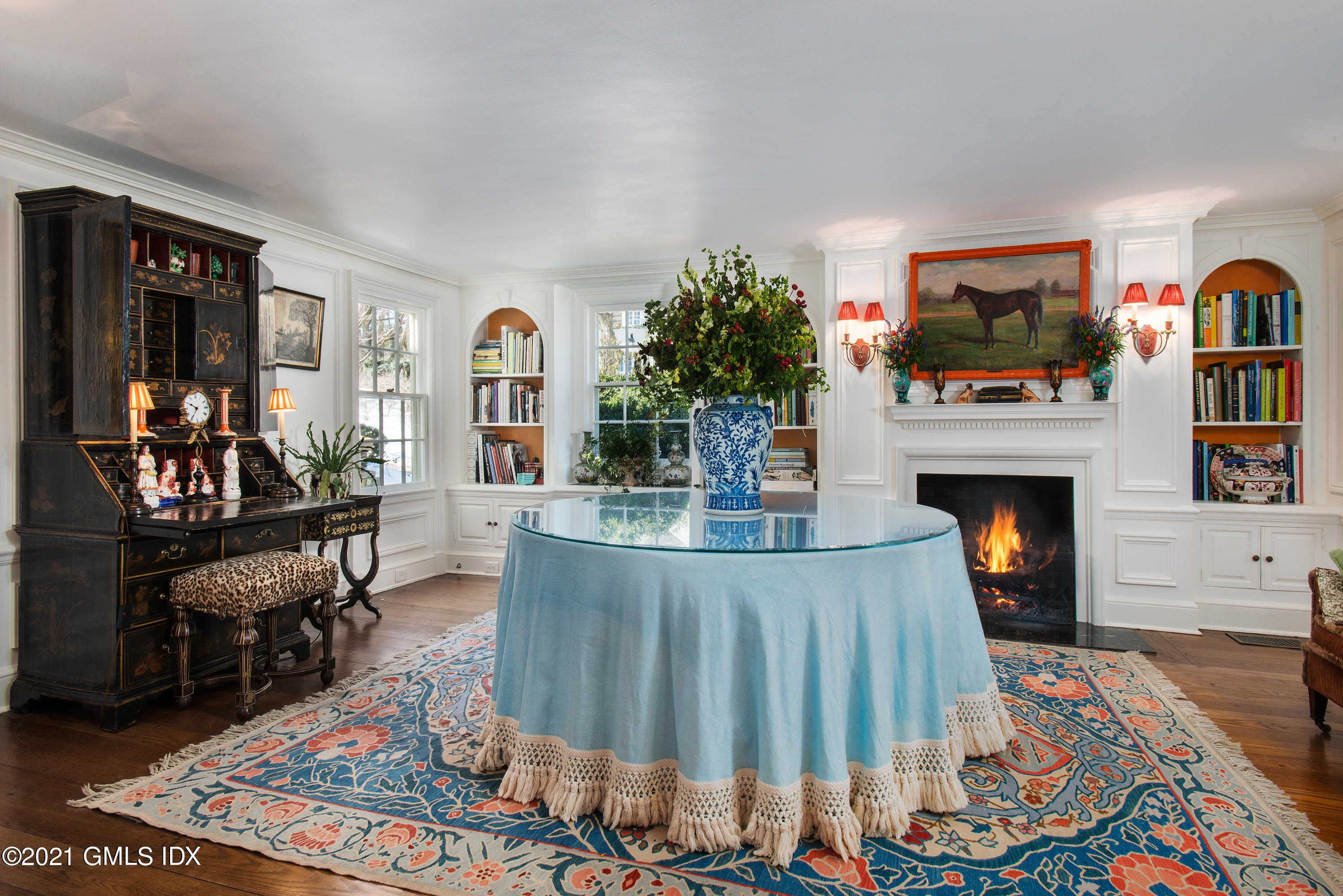 591 Riversville Road Greenwich, CT 06831 - Photo 11 of 79 a living room with furniture a flat screen tv and a fireplace