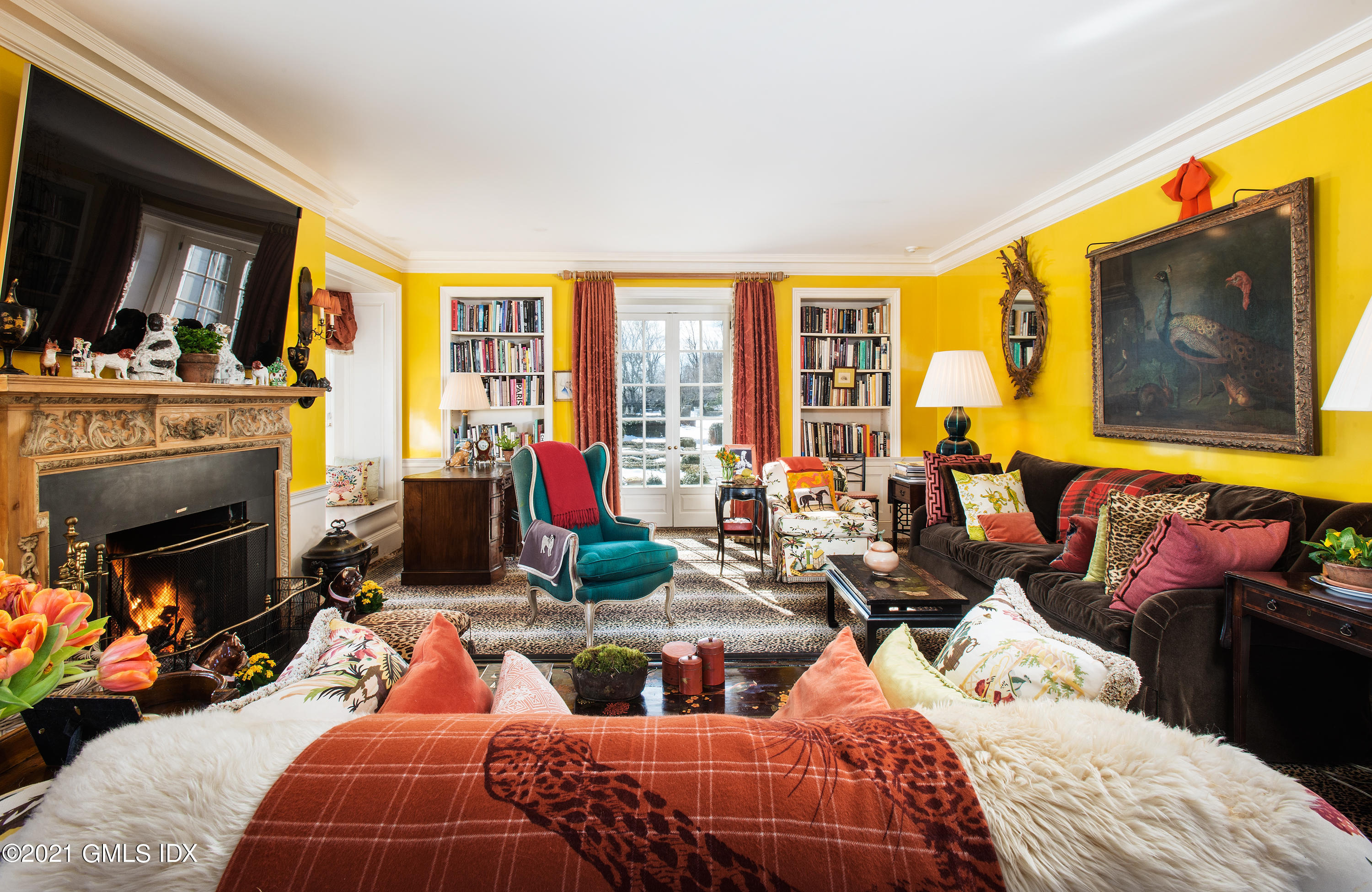 591 Riversville Road Greenwich, CT 06831 - Photo 17 of 79 a bedroom with furniture a fireplace and a flat screen tv