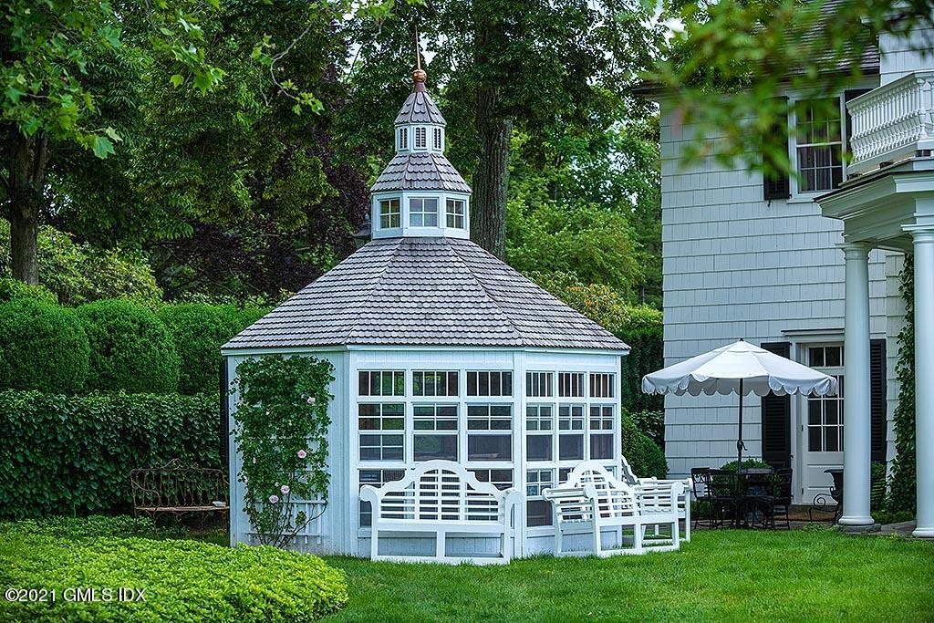 591 Riversville Road Greenwich, CT 06831 - Photo 35 of 79 a front view of a house with a yard