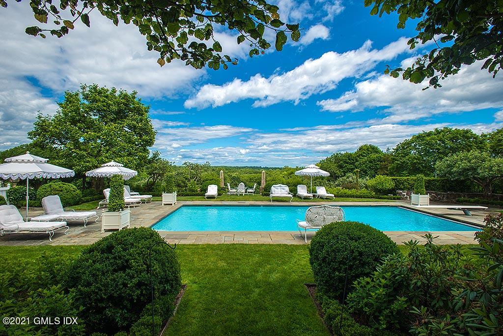 591 Riversville Road Greenwich, CT 06831 - Photo 43 of 79 a view of a swimming pool with lounge chair