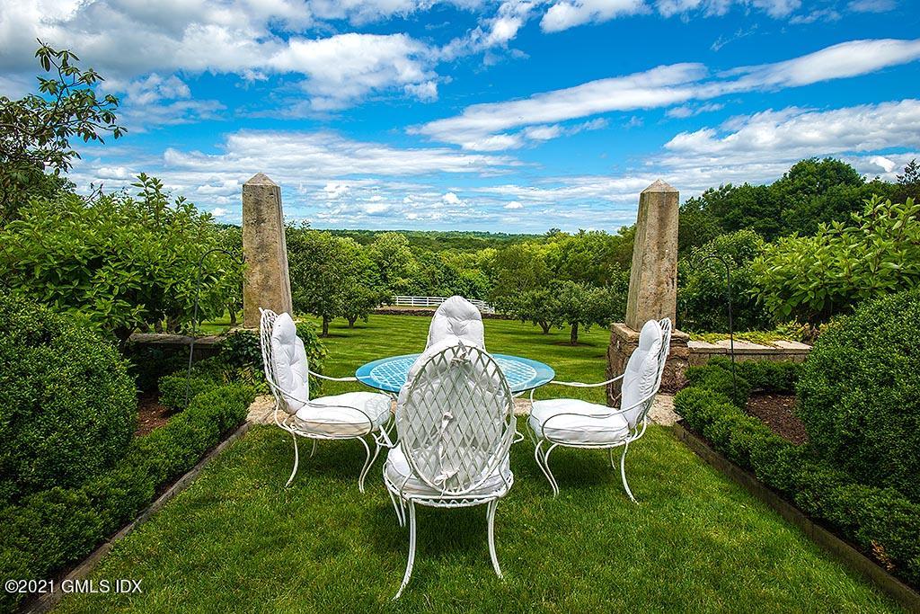 591 Riversville Road Greenwich, CT 06831 - Photo 49 of 79 a view of a table and chairs in the garden