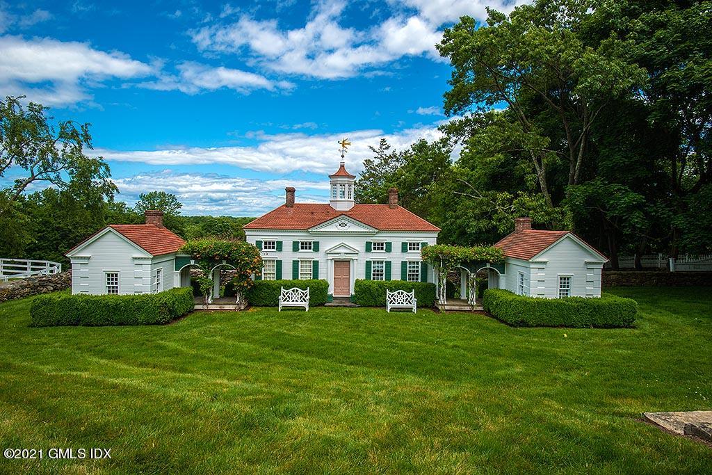 591 Riversville Road Greenwich, CT 06831 - Photo 50 of 79 a front view of a house with a yard