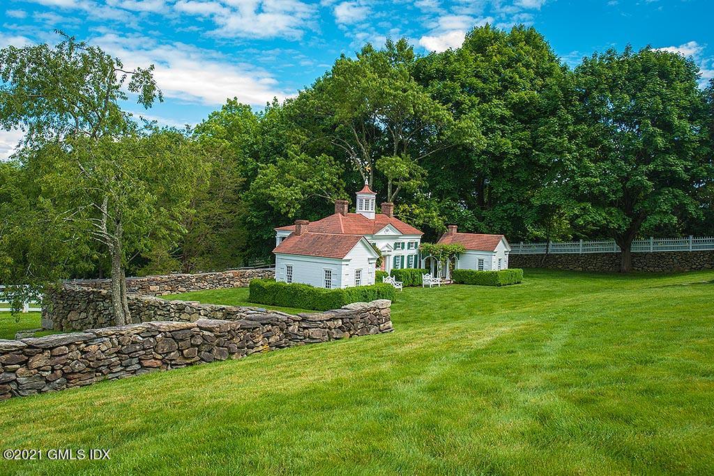 591 Riversville Road Greenwich, CT 06831 - Photo 57 of 79 a front view of a house with a garden