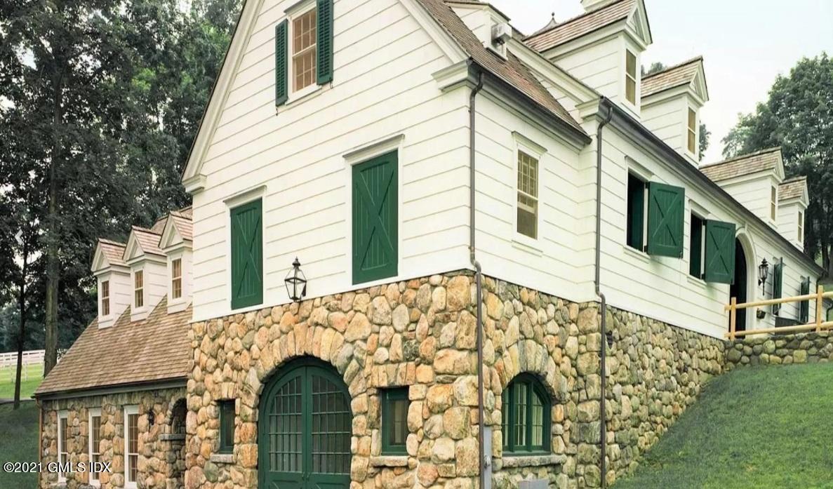 591 Riversville Road Greenwich, CT 06831 - Photo 65 of 79 a front view of a house with a garden