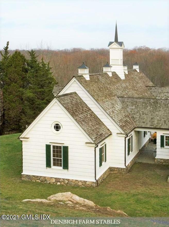 591 Riversville Road Greenwich, CT 06831 - Photo 66 of 79 a front view of a house with a yard