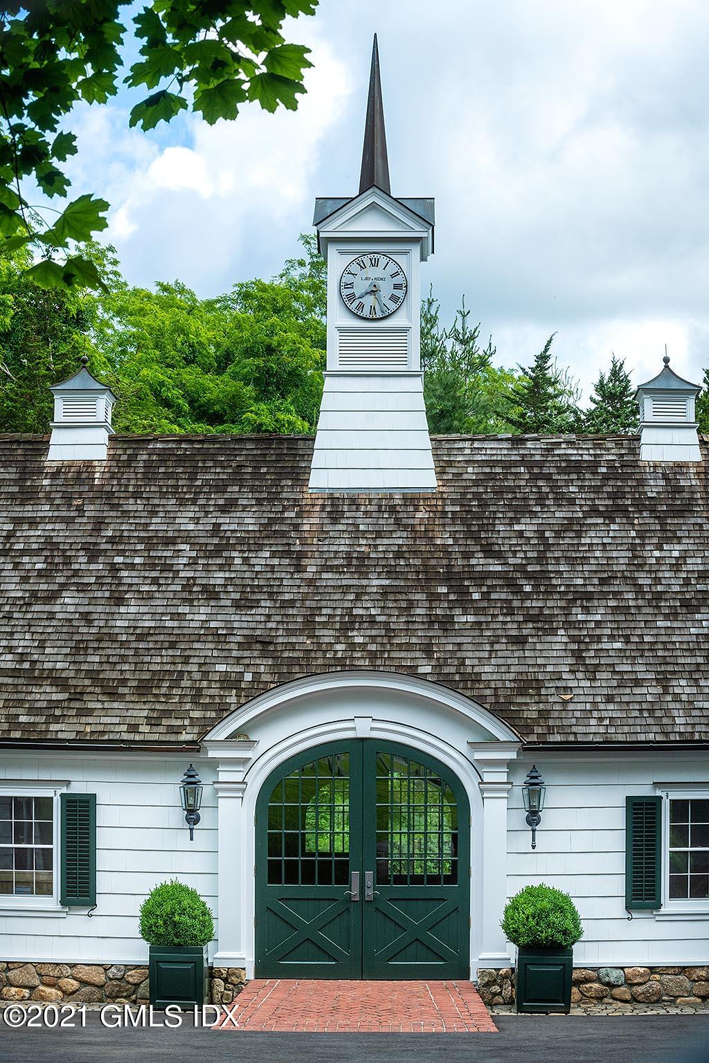591 Riversville Road Greenwich, CT 06831 - Photo 69 of 79 a front view of a house with garden