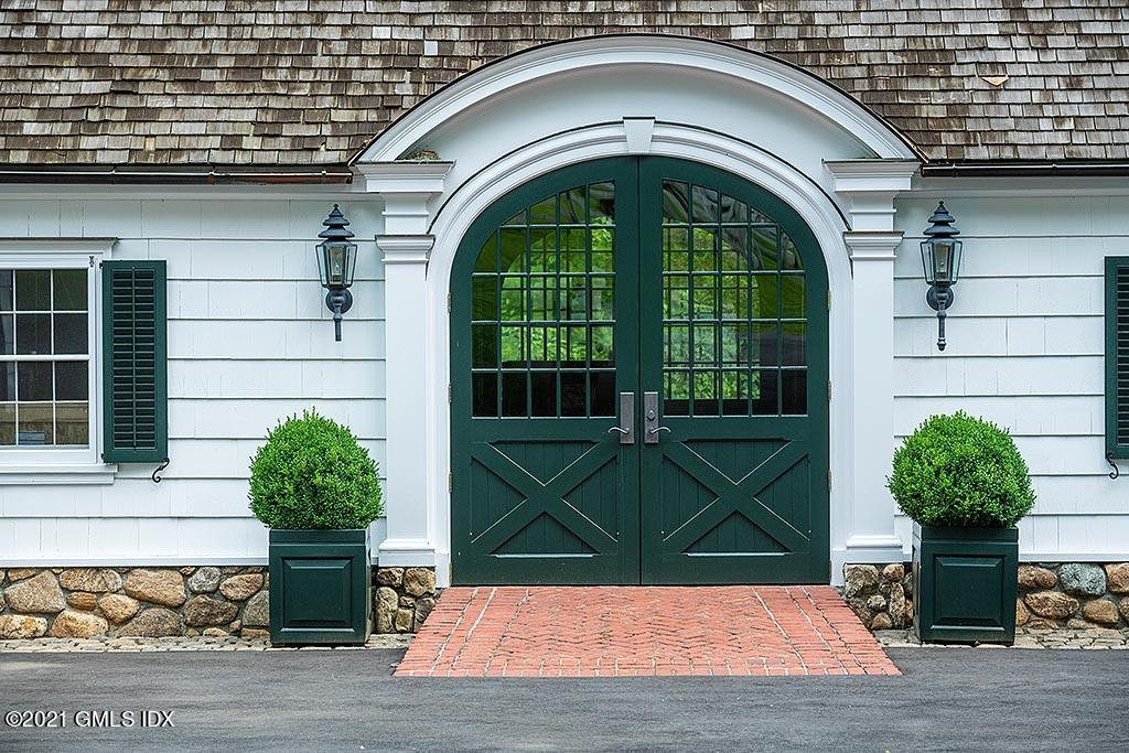 591 Riversville Road Greenwich, CT 06831 - Photo 70 of 79 a front view of a house with garden
