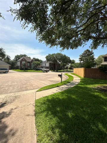 a view of yard with swimming pool and green space