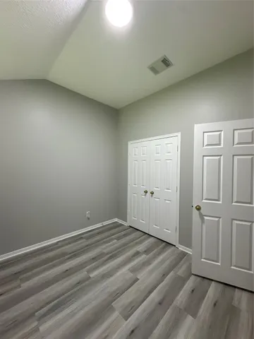 a view of a room with wooden floor
