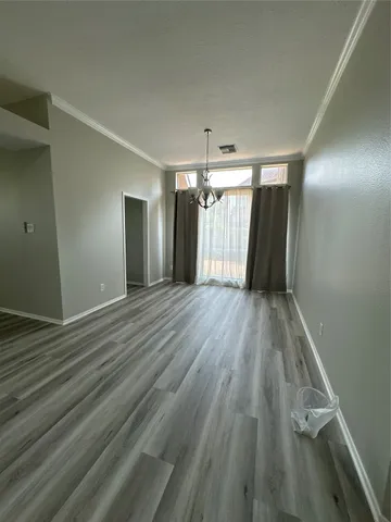 a view of hallway with wooden floor