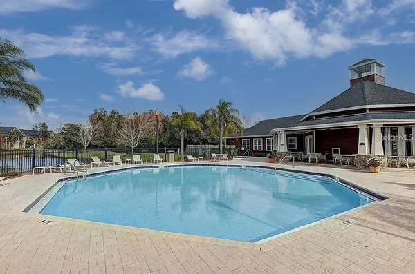 a view of a house with swimming pool and sitting area