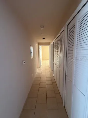 a hallway with sliding door and yard in back