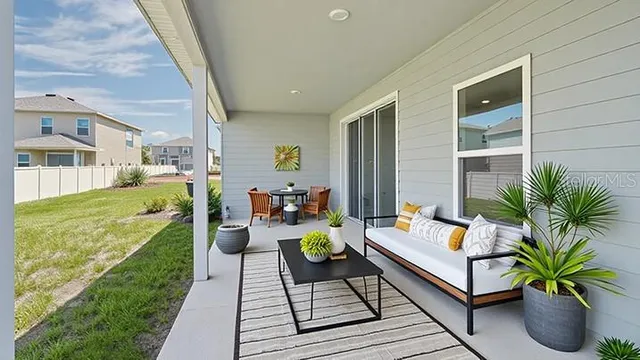 a living room with patio furniture and a patio
