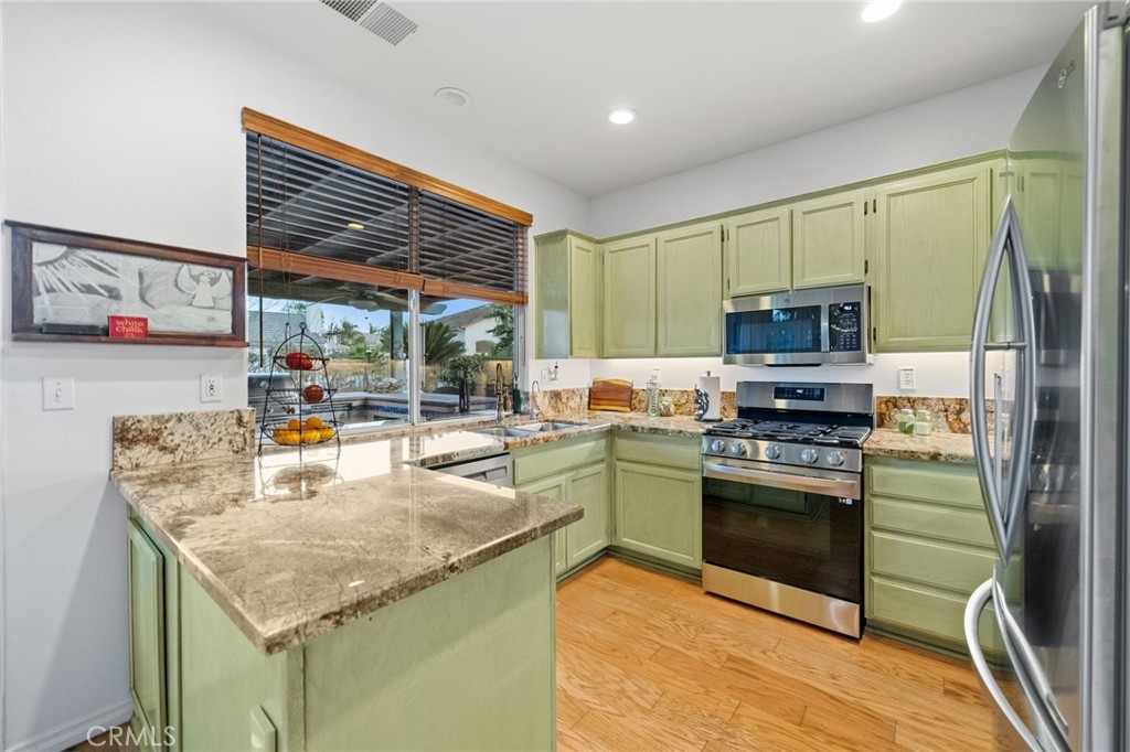 31782 Via San Carlos Temecula, CA 92592 - Photo 18 of 69 a kitchen with stainless steel appliances granite countertop a stove top oven a sink and a refrigerator