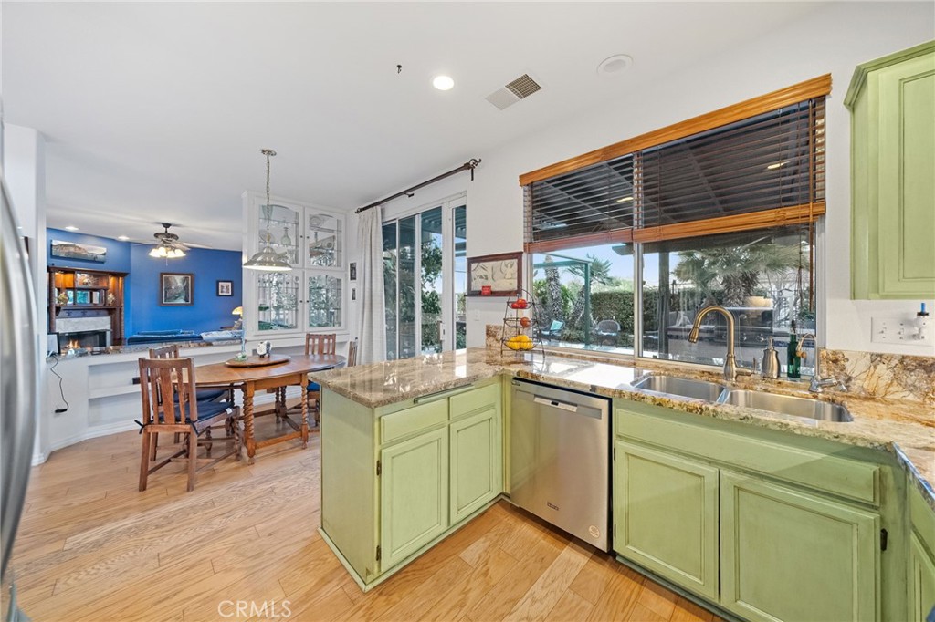 31782 Via San Carlos Temecula, CA 92592 - Photo 19 of 69 a kitchen with a sink and wooden cabinets