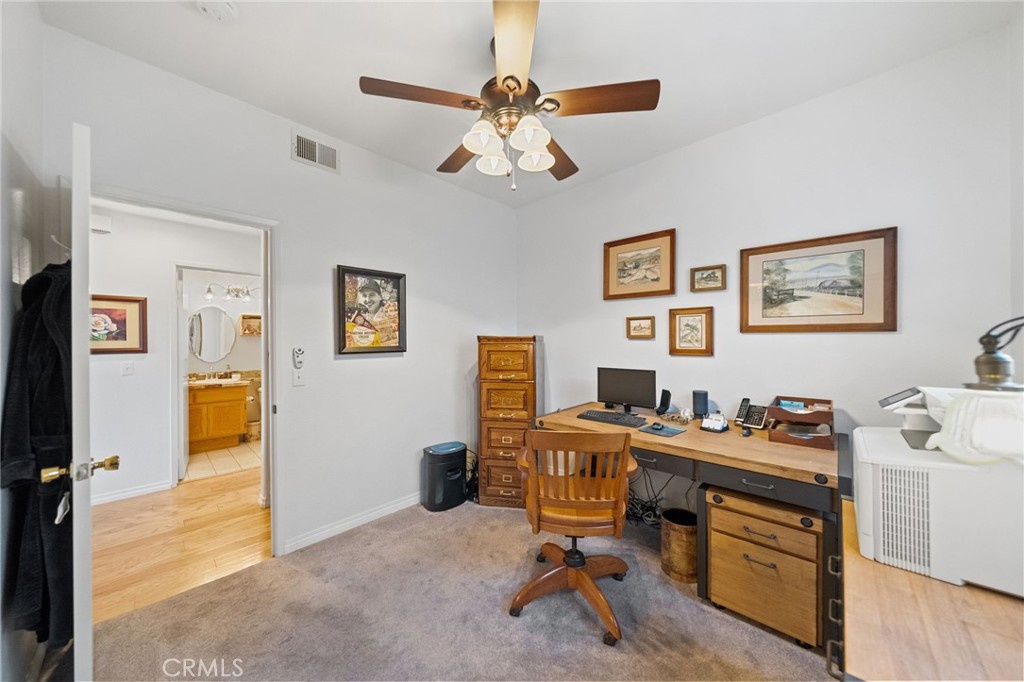 31782 Via San Carlos Temecula, CA 92592 - Photo 24 of 69 a view of a workspace with furniture and a bedroom