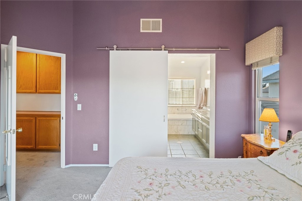 31782 Via San Carlos Temecula, CA 92592 - Photo 36 of 69 a bedroom with a bed and wooden floor