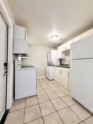 a kitchen with white cabinets a sink and white appliances