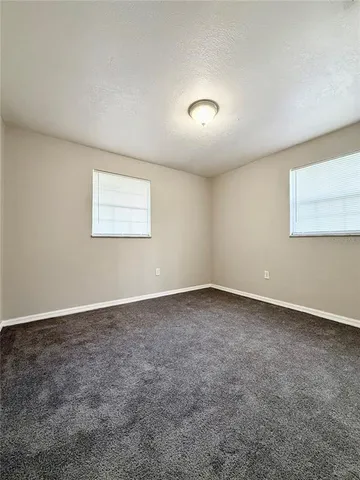 an empty room with a empty space and windows