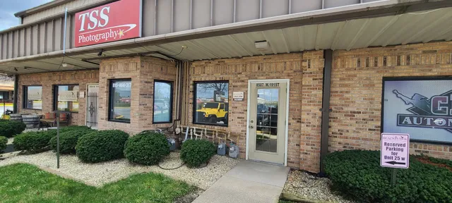 a front view of a building with potted plants