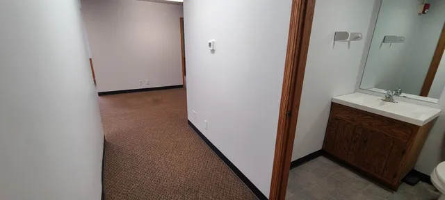 a view of a chairs and table in the back yard of the house
