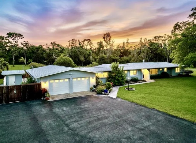 a view of a house with a yard and sitting area