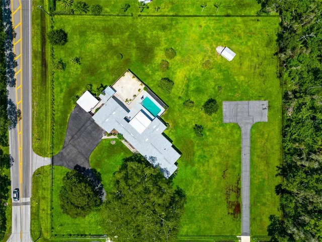 an aerial view of a house with pool yard outdoor seating and yard