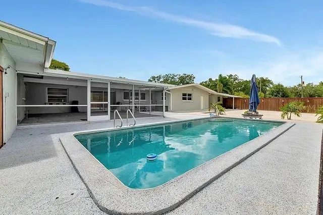 a view of a patio with table and chairs and potted plants