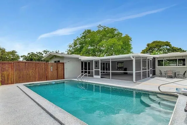 a backyard of a house with table and chairs