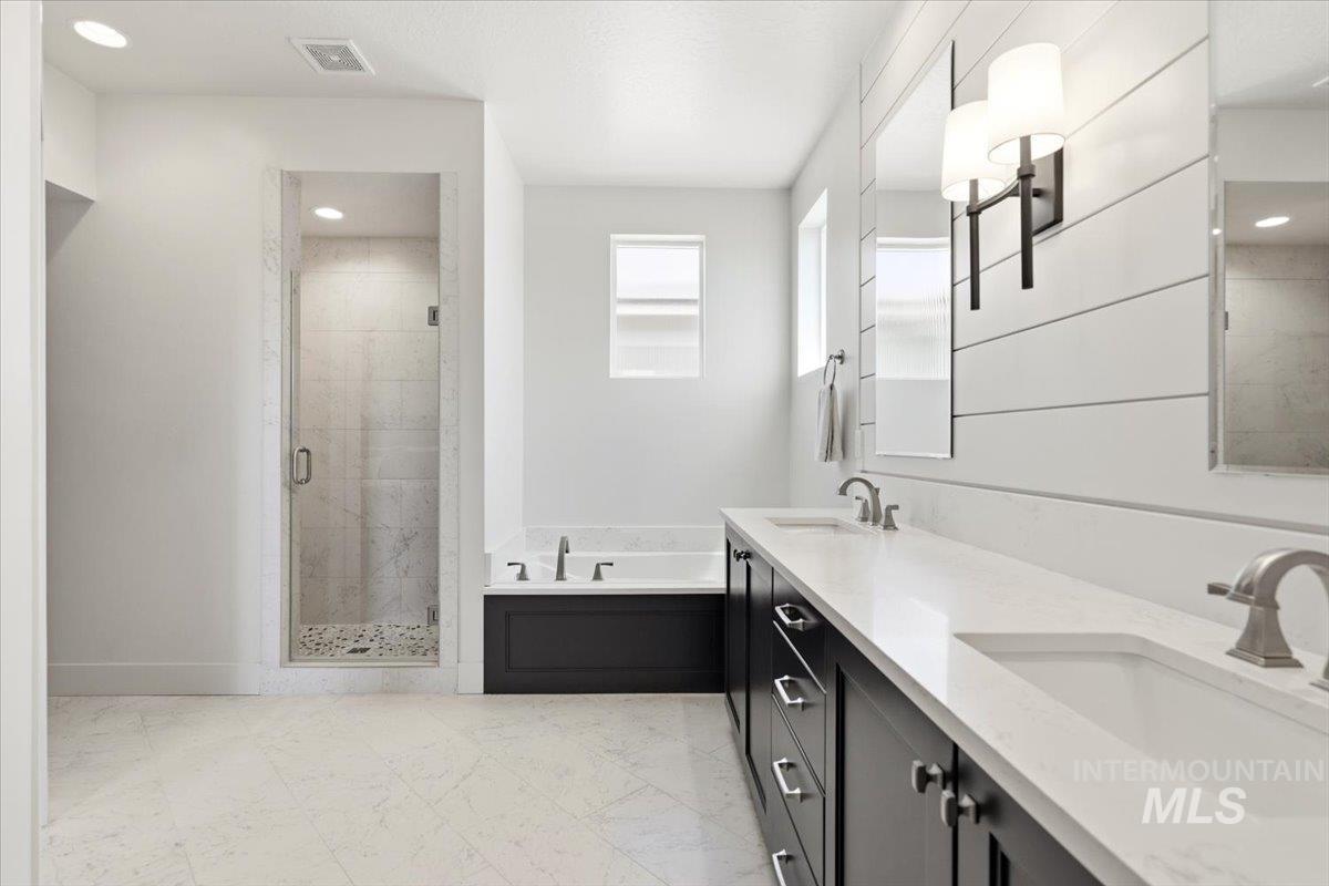 3794 South Single Tree Avenue Boise, ID 83716 - Photo 30 of 50 Bathroom featuring a dual vanity with dark wood cabinetry, white countertops, and undermount sinks
