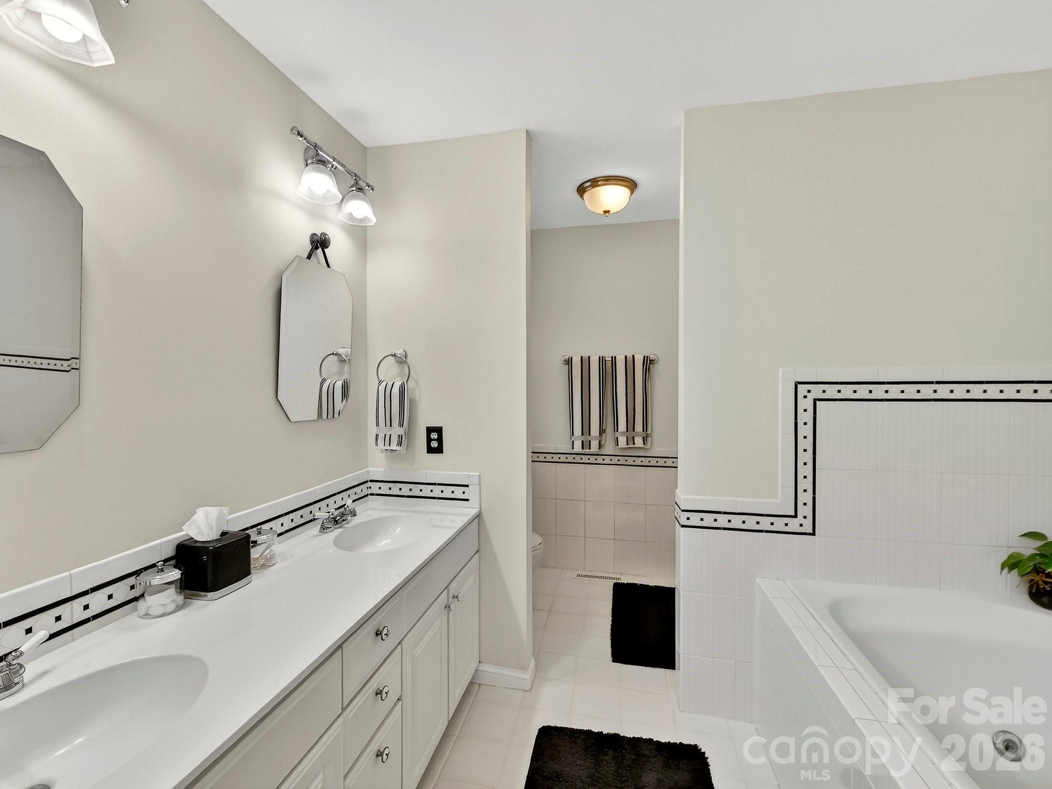 1535 Providence Road Charlotte, NC 28207 - Photo 15 of 42 a bathroom with a sink double vanity and a tub