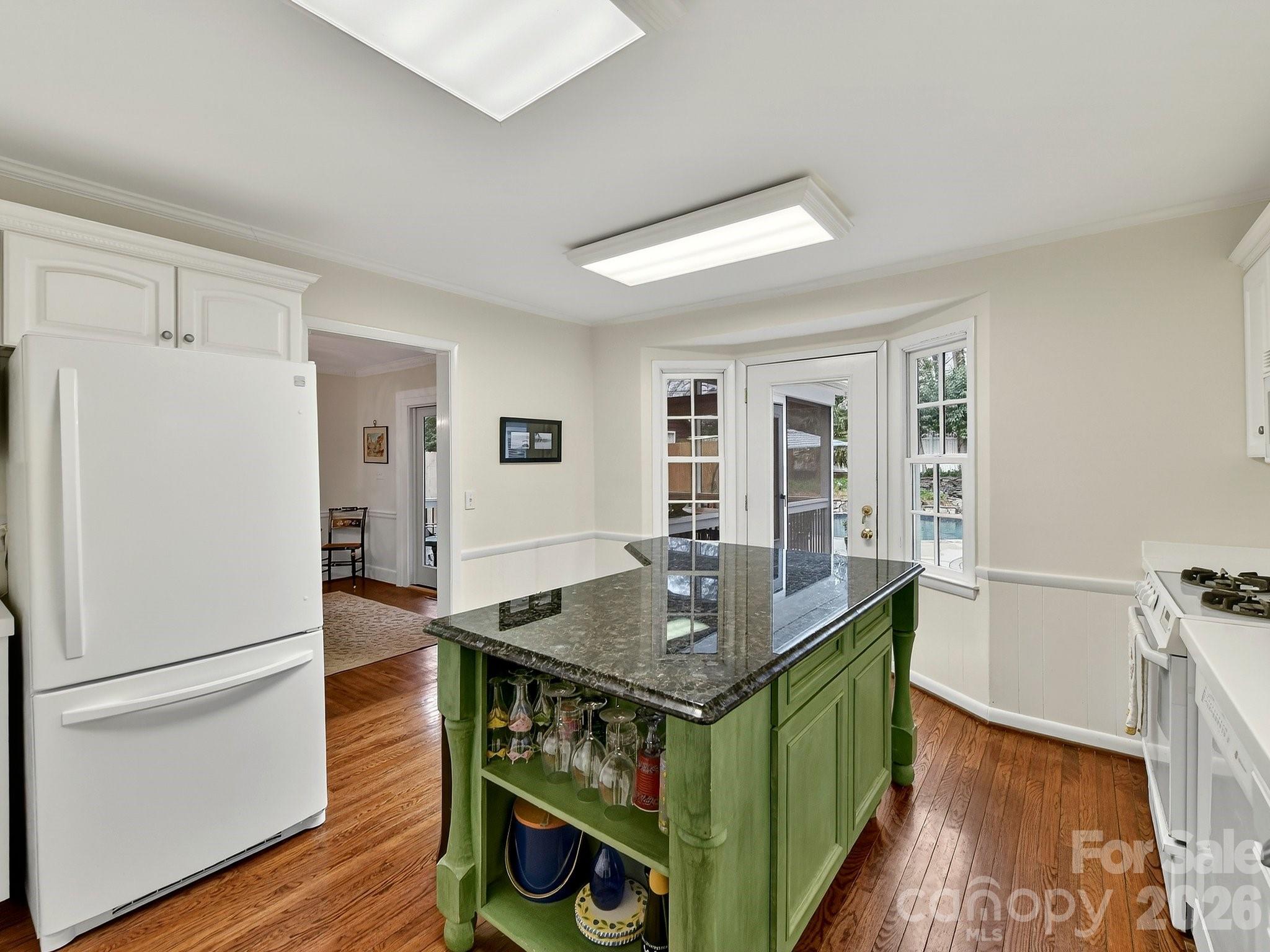 1535 Providence Road Charlotte, NC 28207 - Photo 21 of 42 a view of kitchen island with furniture and wooden floor