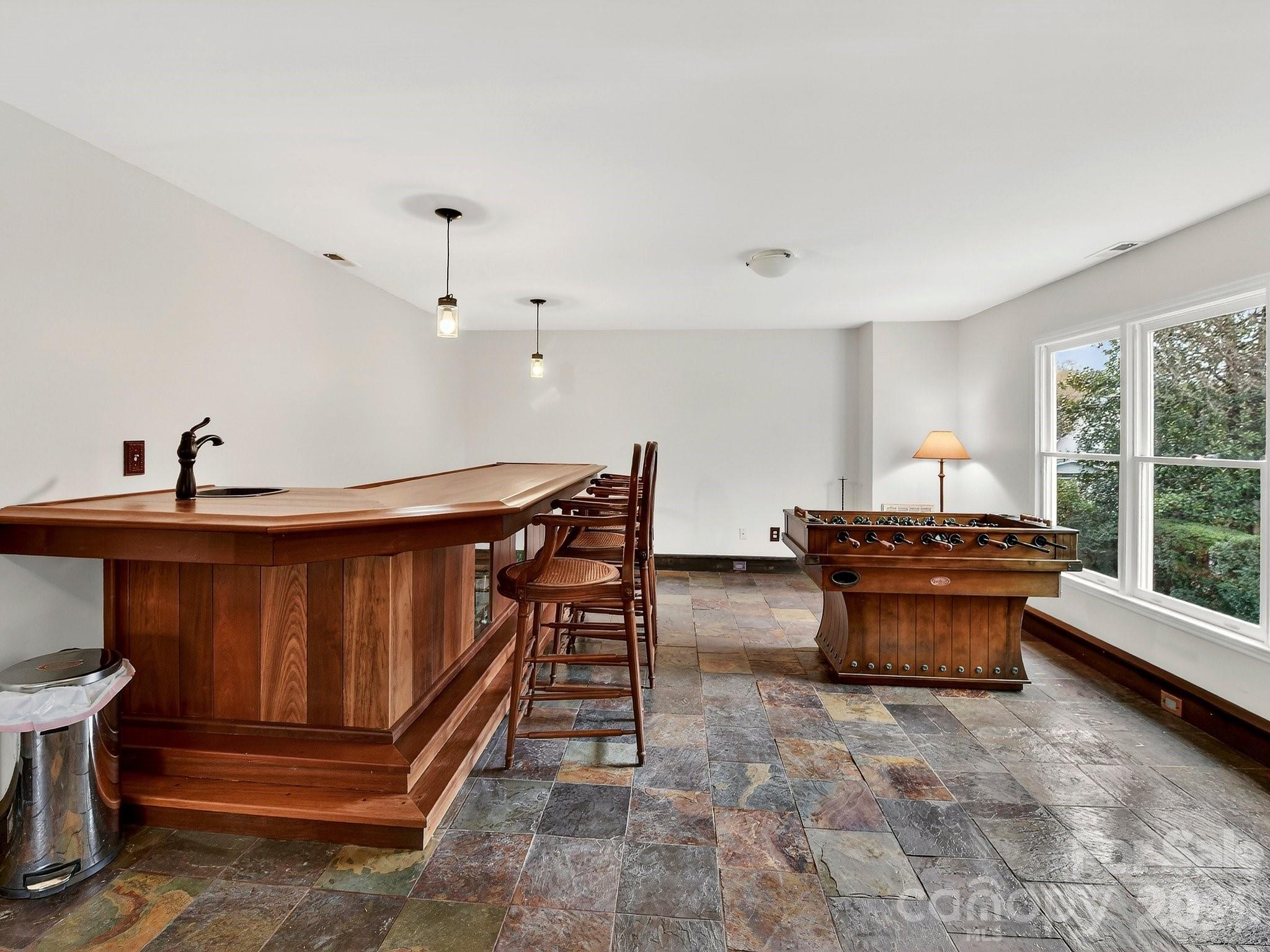 1535 Providence Road Charlotte, NC 28207 - Photo 24 of 42 a dining room with furniture a rug and a chandelier
