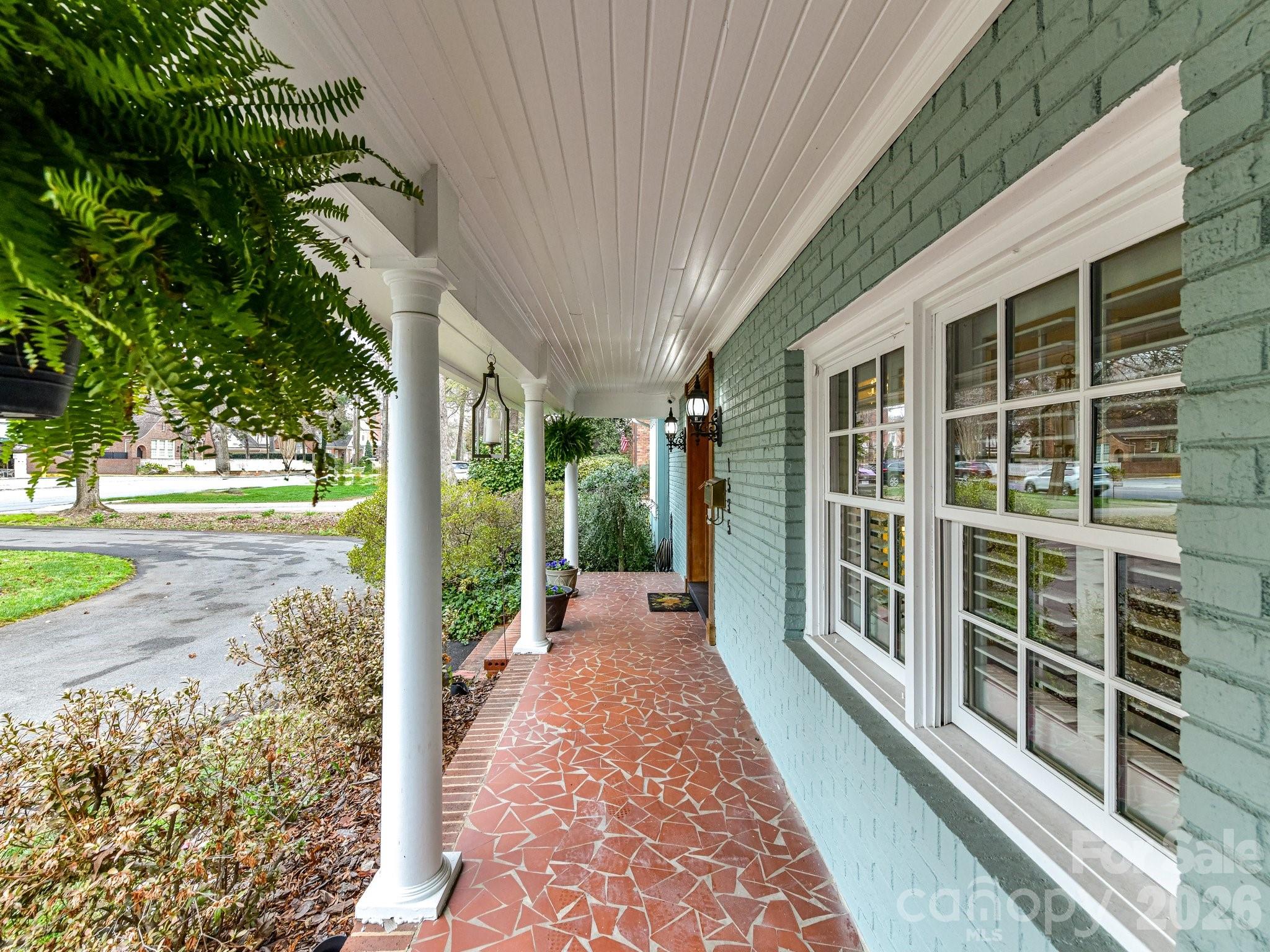 1535 Providence Road Charlotte, NC 28207 - Photo 3 of 42 a view of a porch with wooden floor and roof with a garden view