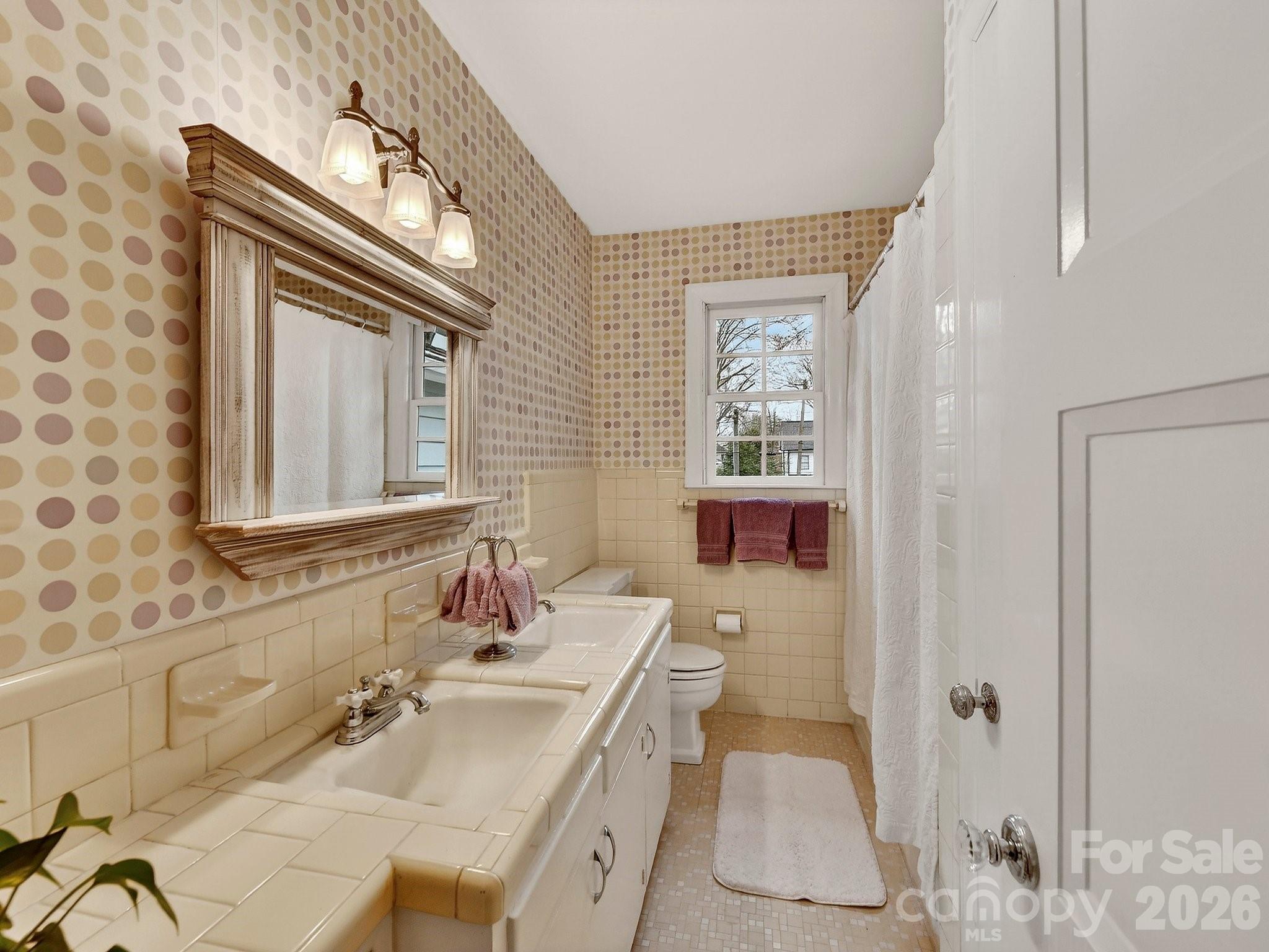 1535 Providence Road Charlotte, NC 28207 - Photo 31 of 42 a bathroom with a sink vanity granite tub and shower
