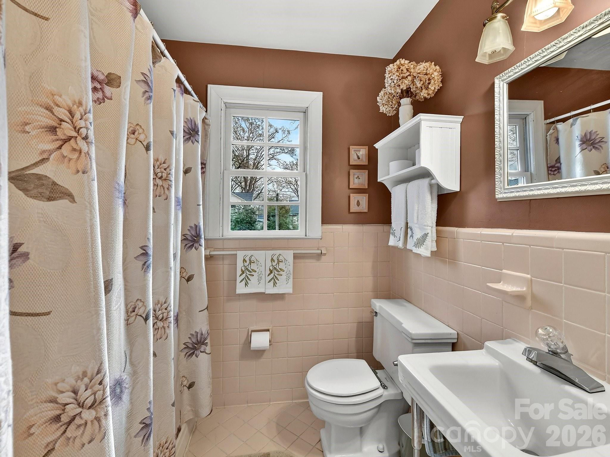 1535 Providence Road Charlotte, NC 28207 - Photo 34 of 42 a bathroom with a toilet sink and mirror