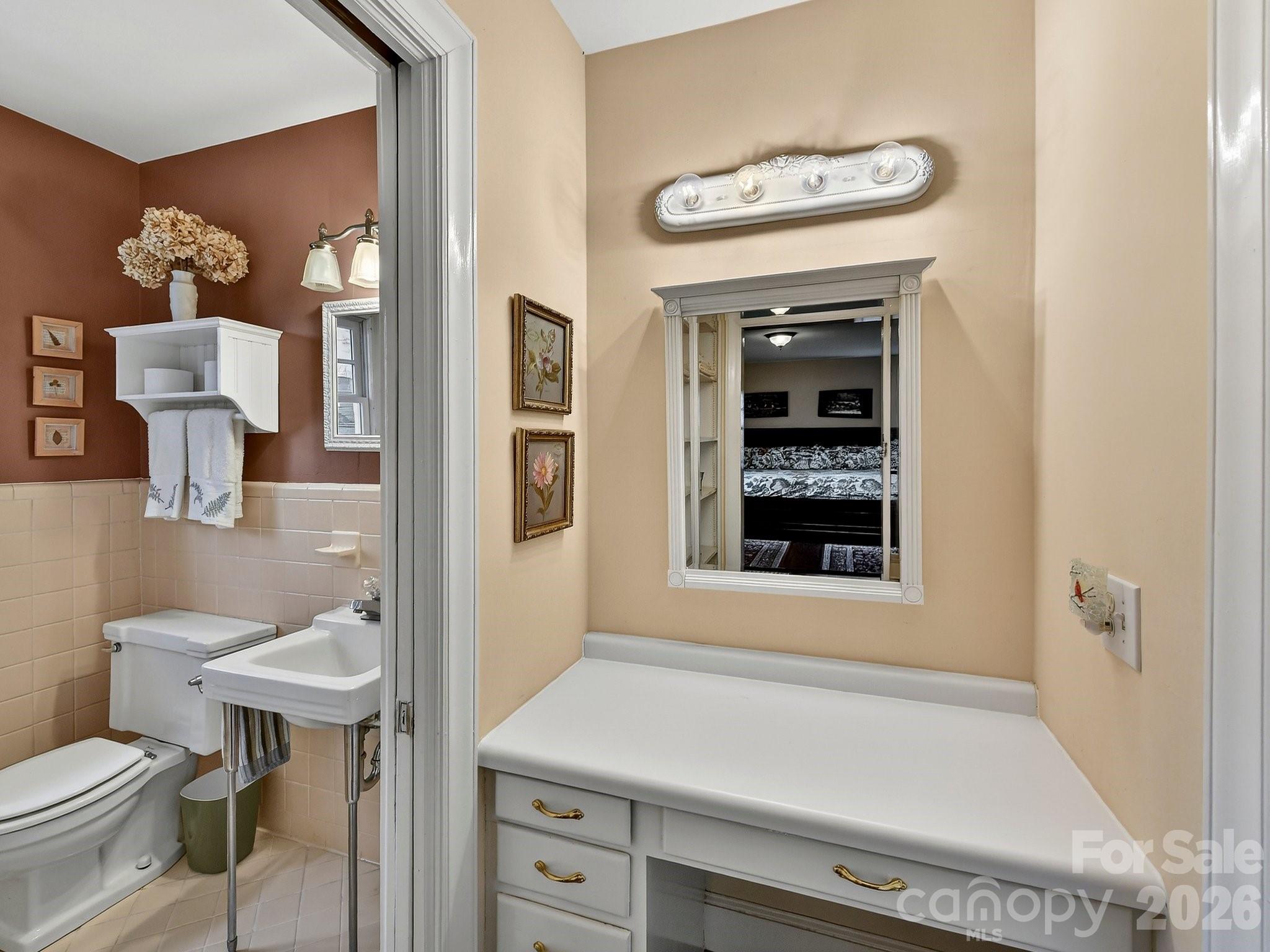1535 Providence Road Charlotte, NC 28207 - Photo 35 of 42 a bathroom with a sink a toilet and a window
