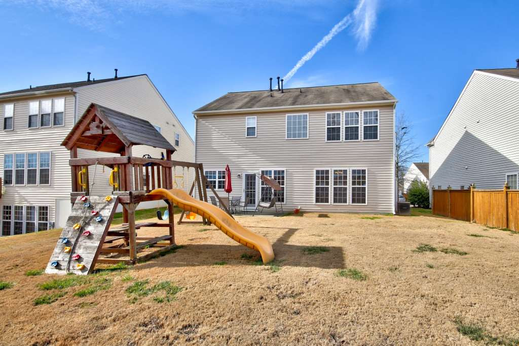 7754 San Gabriel Street Raleigh, NC 27613 - Photo 24 of 25 Great yard to play in! Grill out on the patio and let the kids play on the play set! Exterior Back