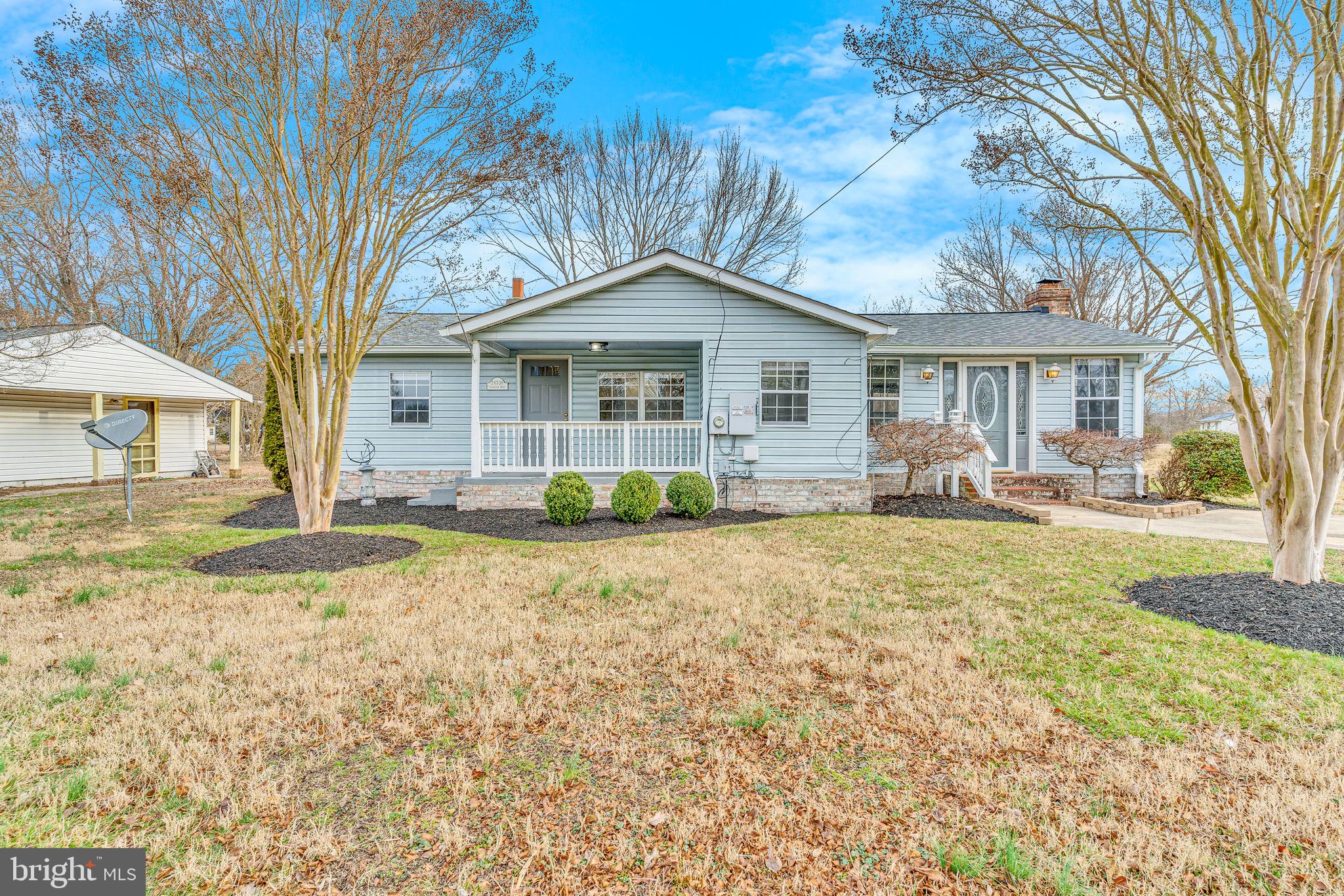 24338 Longview Road Chaptico, MD 20621 - Photo 1 of 19 a front view of a house with garden