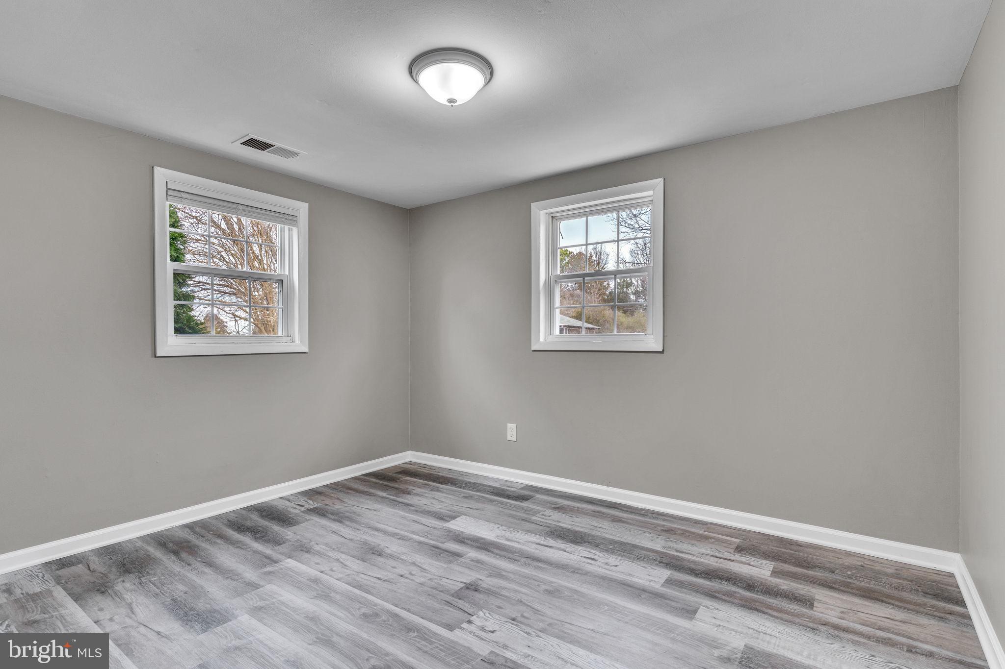 24338 Longview Road Chaptico, MD 20621 - Photo 11 of 19 a view of room with window and wooden floor
