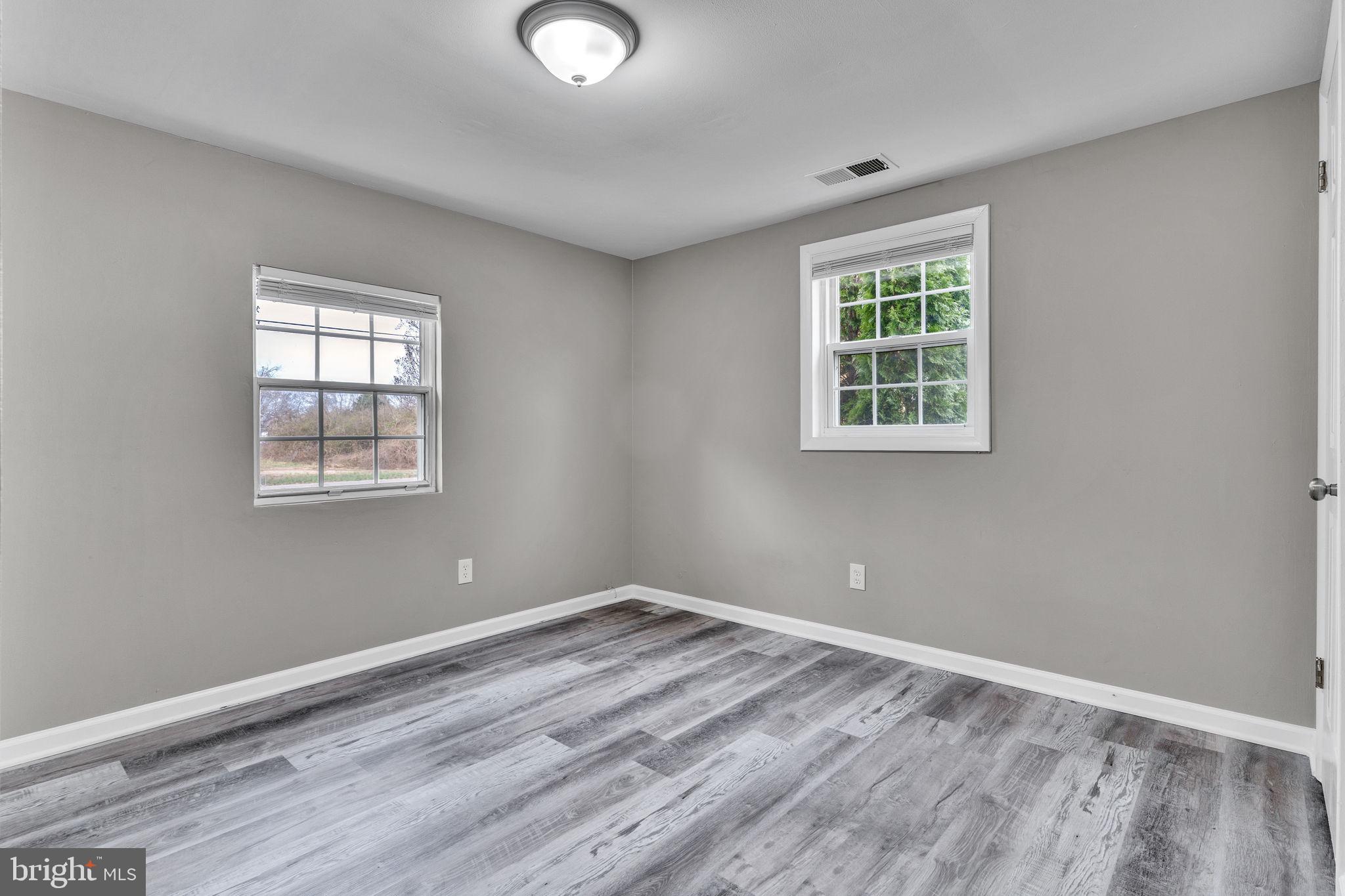 24338 Longview Road Chaptico, MD 20621 - Photo 13 of 19 a view of empty room with wooden floor