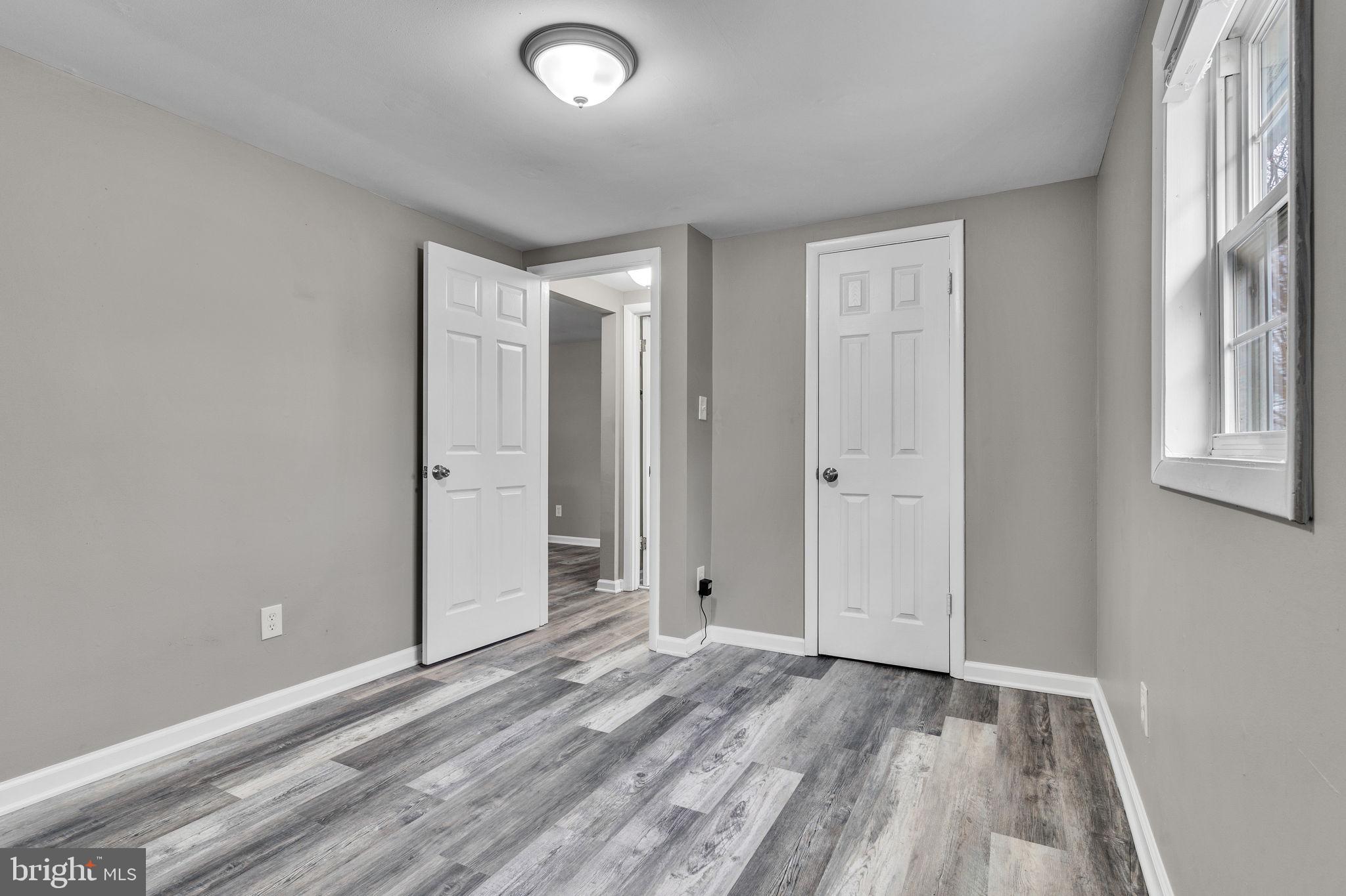 24338 Longview Road Chaptico, MD 20621 - Photo 7 of 19 an empty room with window and wooden floor