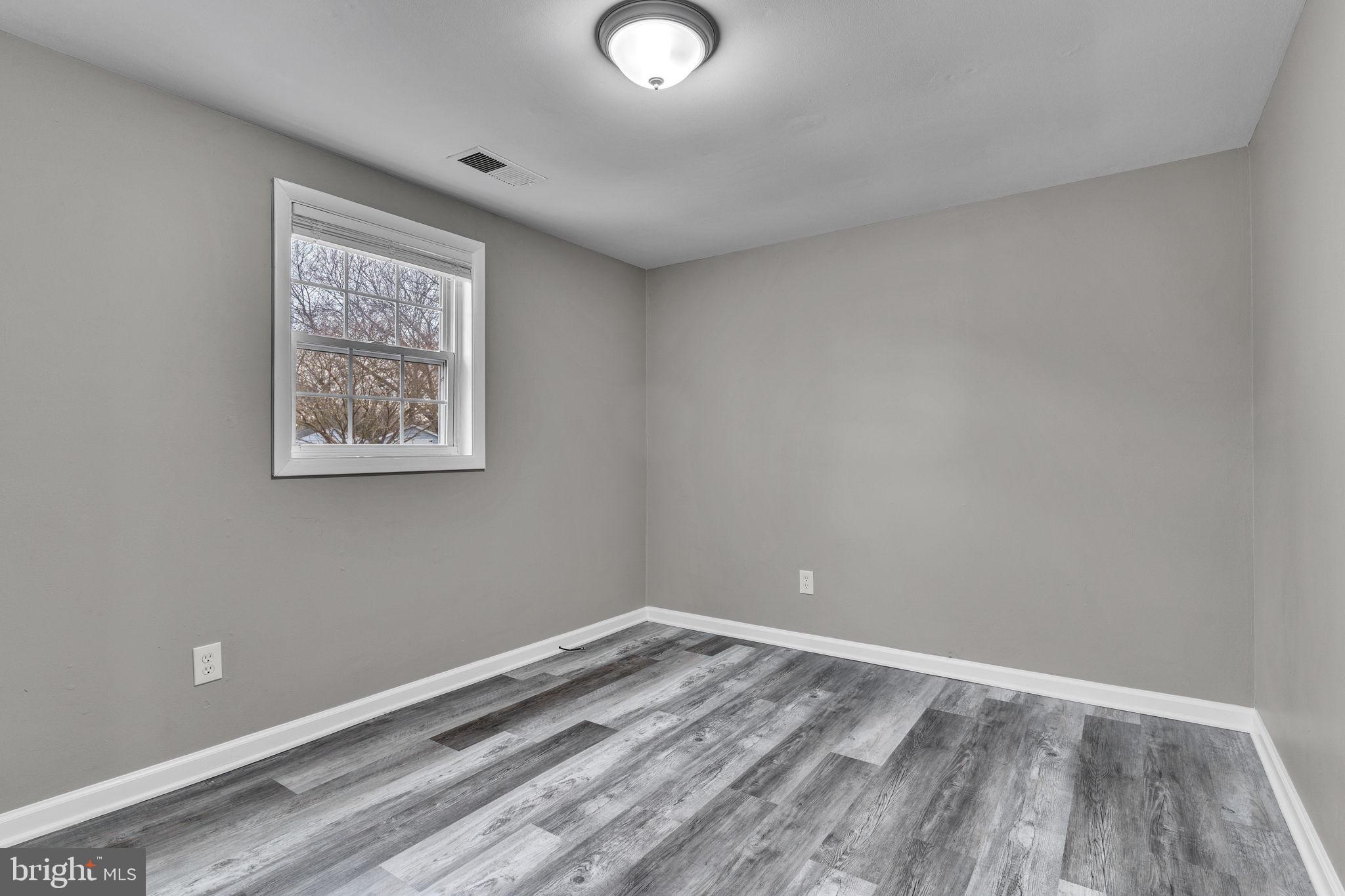24338 Longview Road Chaptico, MD 20621 - Photo 8 of 19 a view of room with window and wooden floor